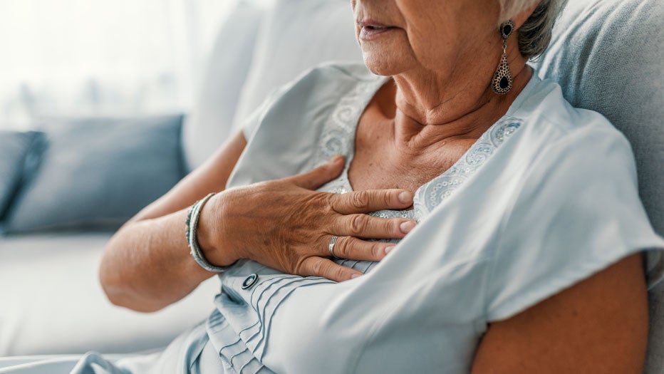 women holding chest