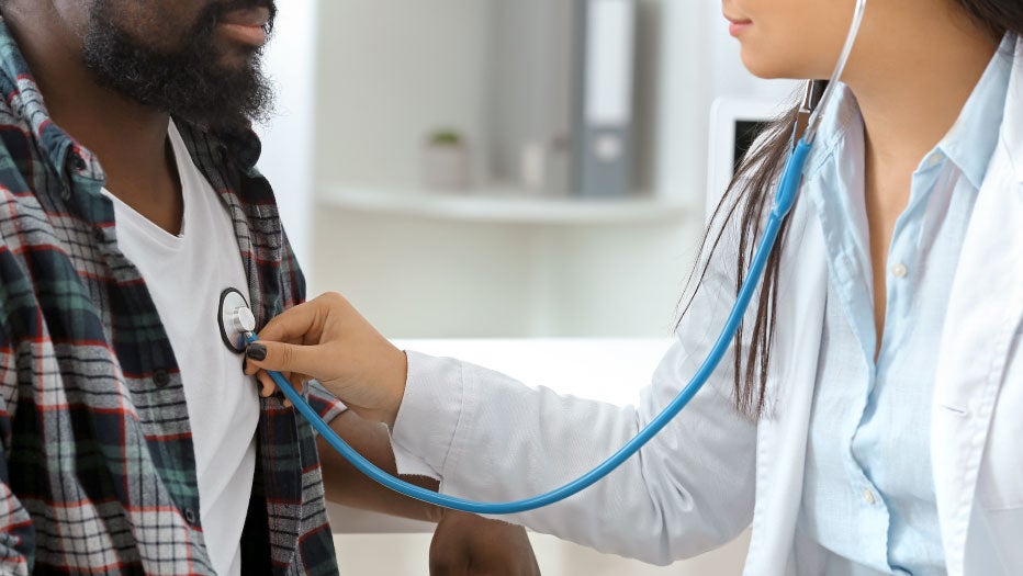 doctor listening to patients heart