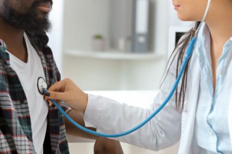 doctor listening to patients heart