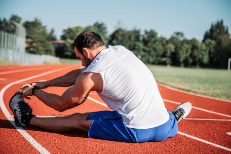 Male runner stretching